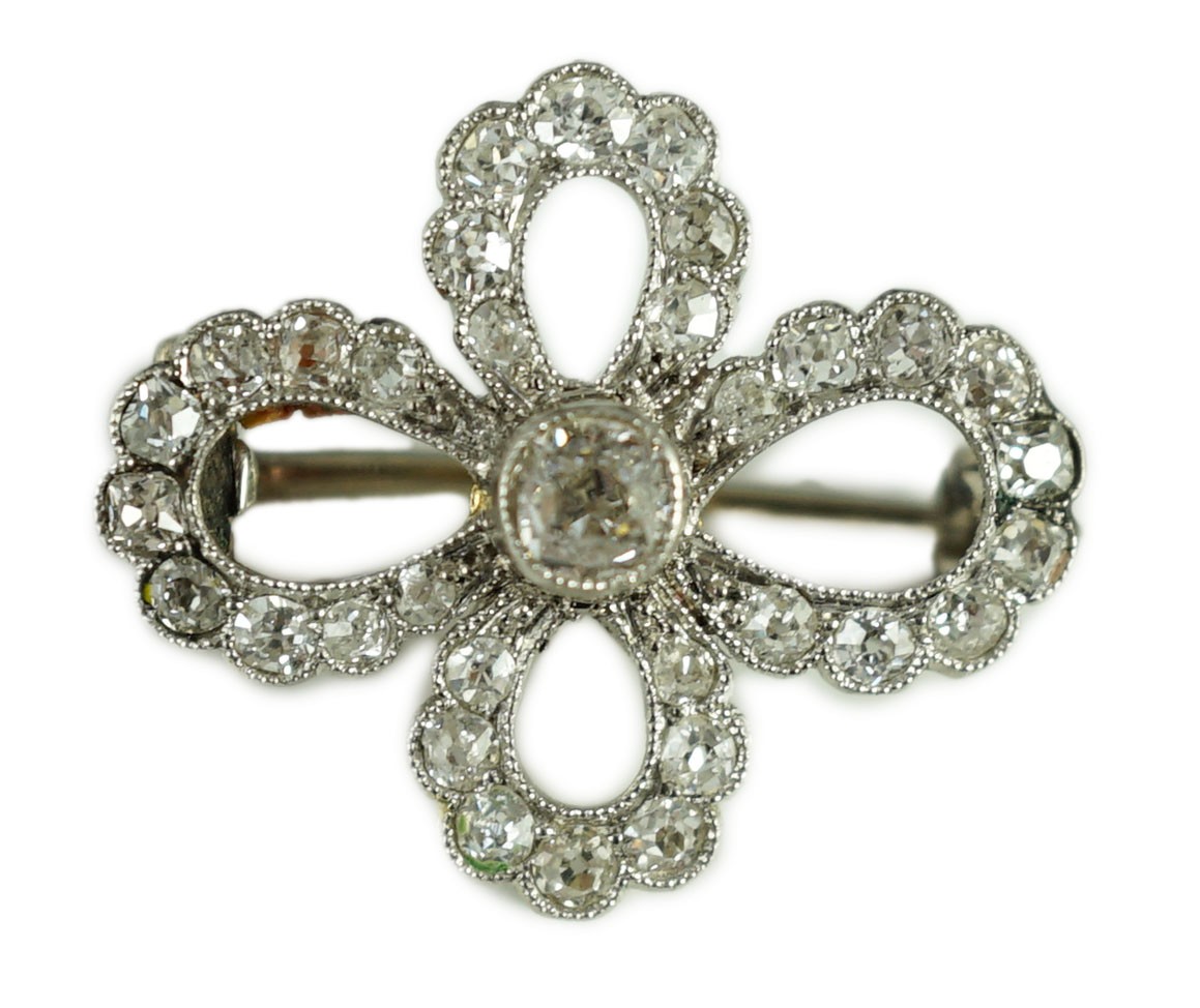 A 1940's white gold? and millegrain set diamond cluster set open work quatrefoil shaped brooch